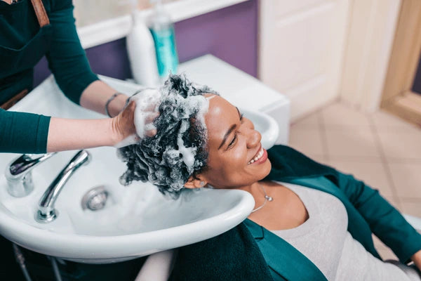 Salon scene with woman getting hair washed
